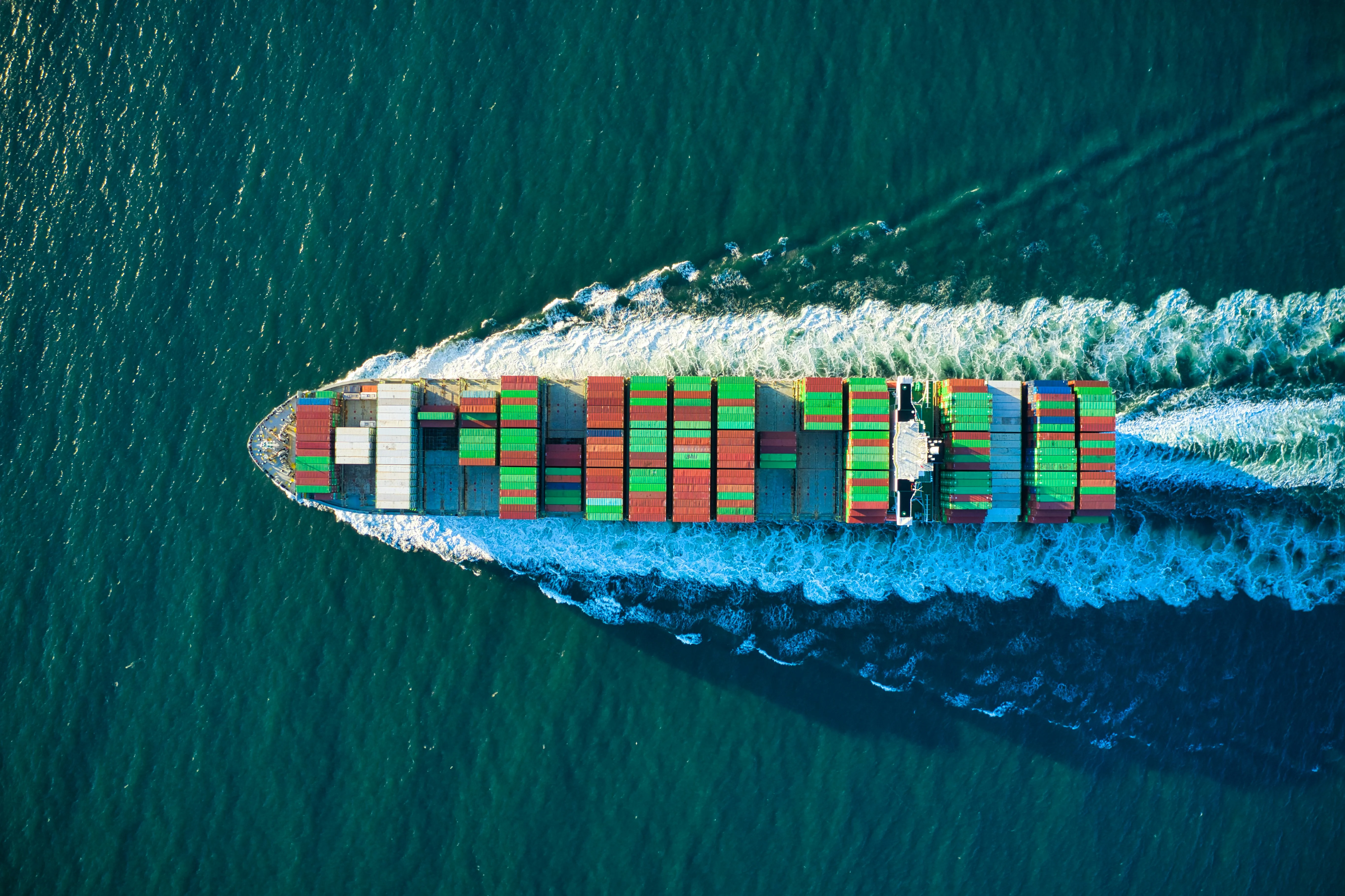 Aerial view of a cargo ship, representing global logistics